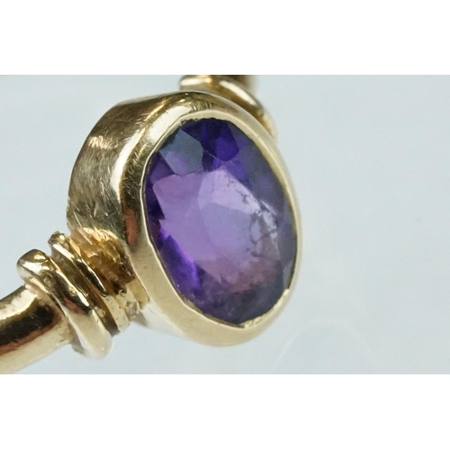 52 - Amethyst 9ct yellow gold ring, the oval mixed cut amethyst measuring approx 6.5mmx 4.5mm, rubover se... 