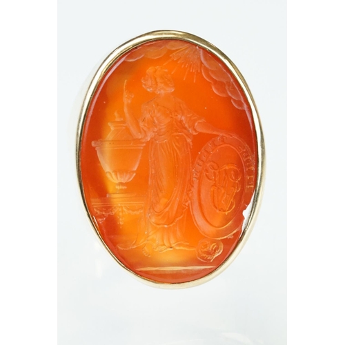 55 - Carnelian intaglio yellow metal ring, the intaglio depicting a Grecian lady with urn and monogrammed... 