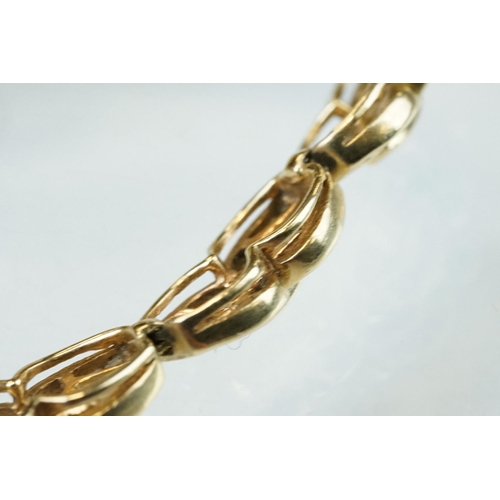 57 - Diamond 14ct yellow gold bracelet, the fancy links full set with tapered baguette cut diamonds, tong... 