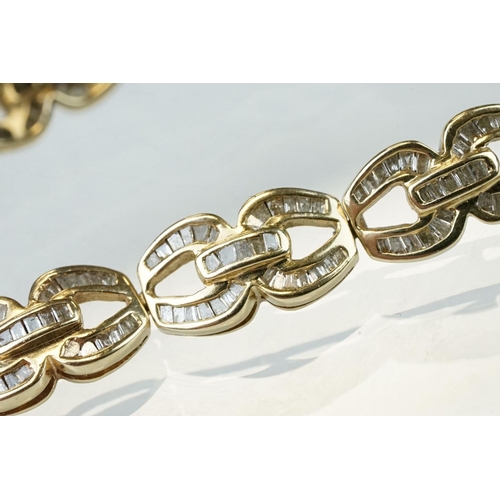 57 - Diamond 14ct yellow gold bracelet, the fancy links full set with tapered baguette cut diamonds, tong... 