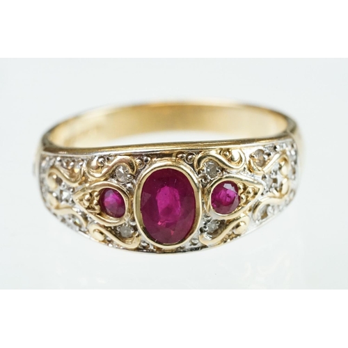 61 - Ruby and diamond 14ct yellow gold ring, the principal oval mixed cut ruby measuring approx 6mm x 4mm... 