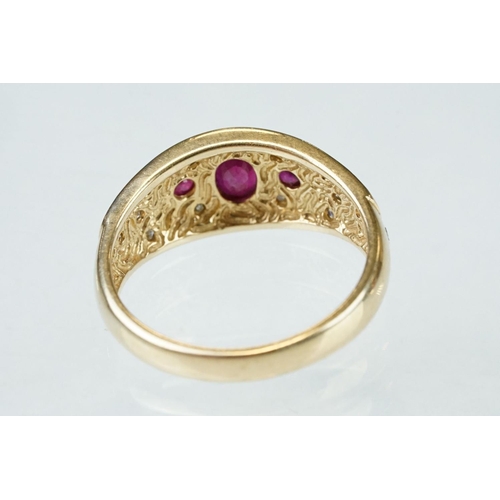 61 - Ruby and diamond 14ct yellow gold ring, the principal oval mixed cut ruby measuring approx 6mm x 4mm... 