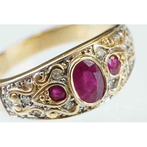 61 - Ruby and diamond 14ct yellow gold ring, the principal oval mixed cut ruby measuring approx 6mm x 4mm... 