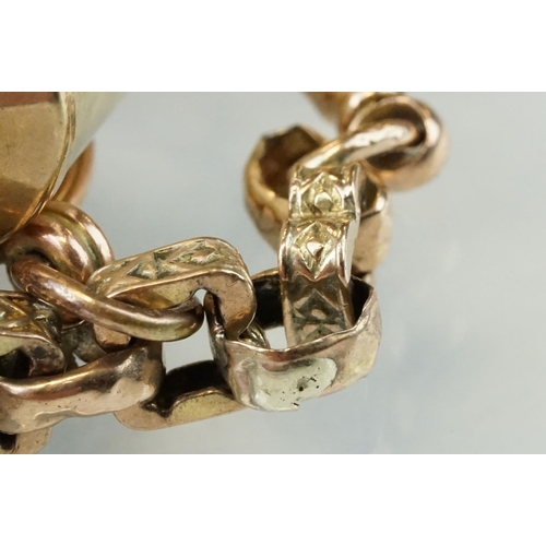 62 - Unmarked rose gold charm bracelet, fancy curb links, 9ct gold toggle, eight 9ct gold charms and fobs... 