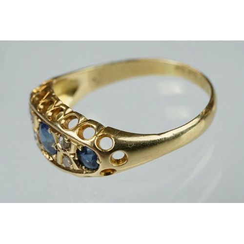 63 - Early 20th century sapphire, blue spinel and diamond 18ct yellow gold boat head ring, centre round m... 