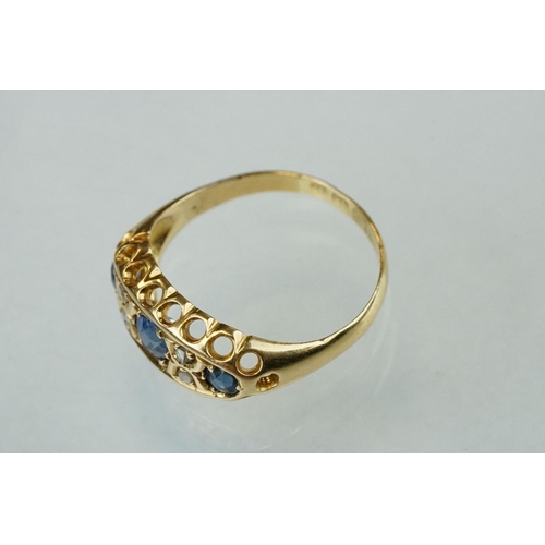 63 - Early 20th century sapphire, blue spinel and diamond 18ct yellow gold boat head ring, centre round m... 