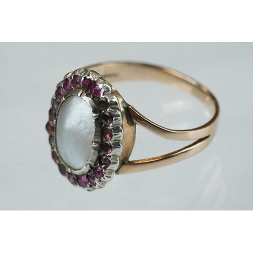 64 - 19th century blister pearl, ruby and garnet rose and white metal cluster ring, the oval blister pear... 