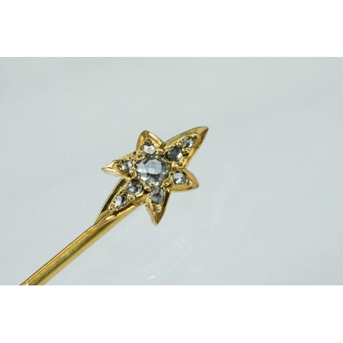 65 - Victorian diamond yellow metal stick pin, the star shaped head set with centre old cut diamond weigh... 