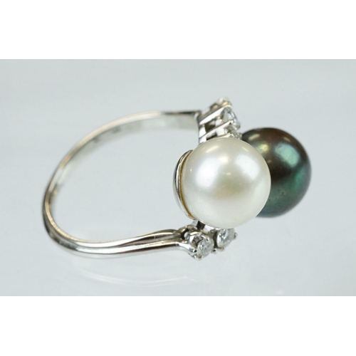 67 - Pearl and diamond unmarked white gold crossover style ring, the black cultured pearl with green over... 