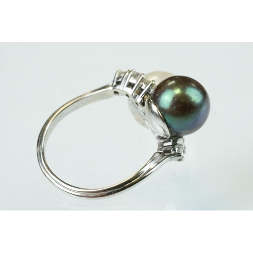 67 - Pearl and diamond unmarked white gold crossover style ring, the black cultured pearl with green over... 