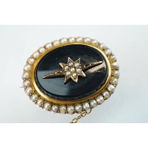 72 - Edwardian seed pearl and black onyx 9ct yellow gold oval brooch, the star-shaped central design full... 