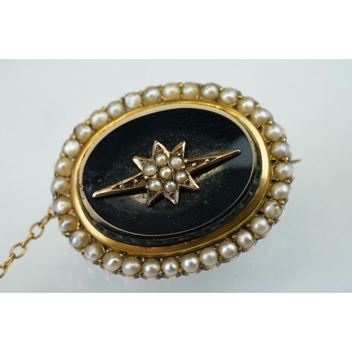 72 - Edwardian seed pearl and black onyx 9ct yellow gold oval brooch, the star-shaped central design full... 