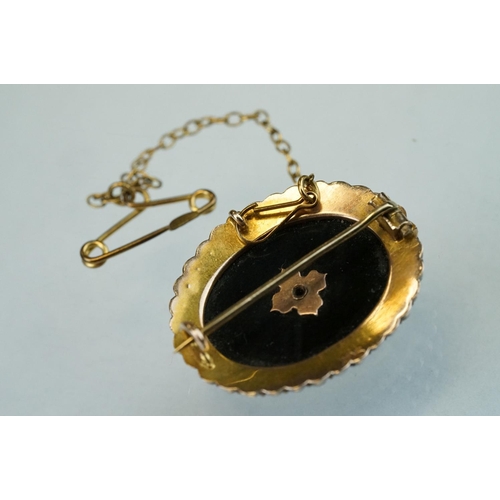 72 - Edwardian seed pearl and black onyx 9ct yellow gold oval brooch, the star-shaped central design full... 