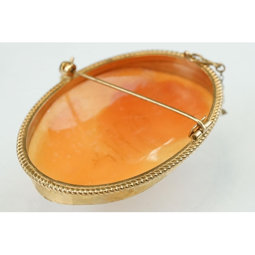 77 - Shell cameo 9ct yellow gold brooch, the cameo depicting female profile, rubover set, rope twist surr... 