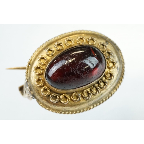 83 - 19th century garnet carbuncle yellow metal oval brooch, the oval cabochon cut garnet measuring appro... 