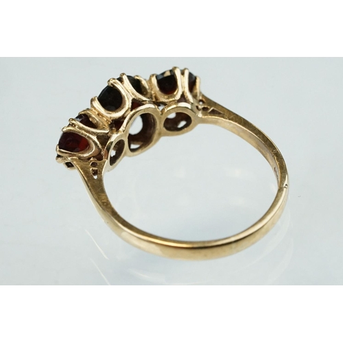 86 - Garnet 9ct yellow gold three stone, ring, the central oval mixed cut garnet measuring approx 8mm x 5... 