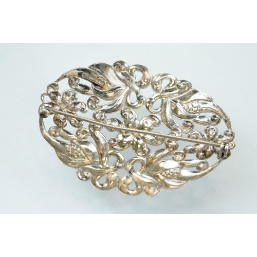 91 - Silver target brooch with blank shield shaped cartouche to centre, rrepoussé floral surround, diamet... 