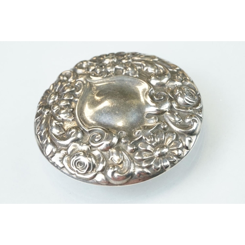 91 - Silver target brooch with blank shield shaped cartouche to centre, rrepoussé floral surround, diamet... 