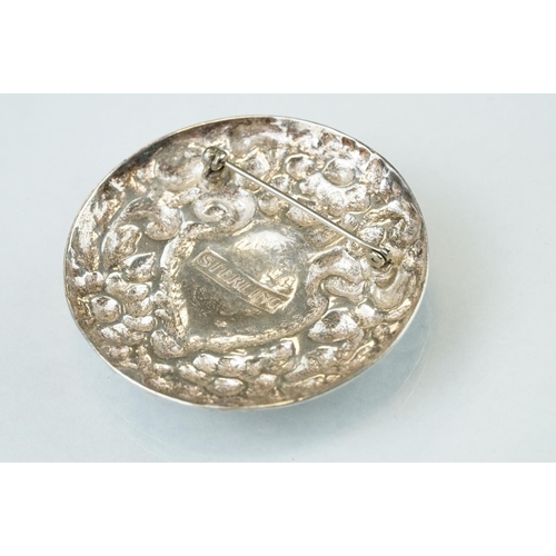 91 - Silver target brooch with blank shield shaped cartouche to centre, rrepoussé floral surround, diamet... 