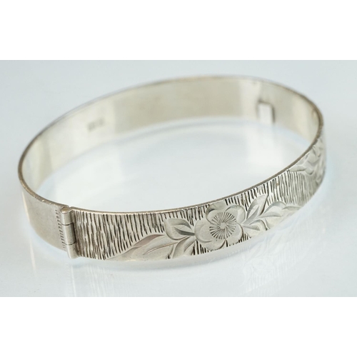 98 - Four silver hinged bangles, together with a Rennie Macintosh style cubic zirconia set silver bangle ... 