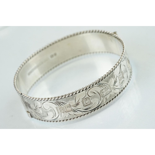 98 - Four silver hinged bangles, together with a Rennie Macintosh style cubic zirconia set silver bangle ... 