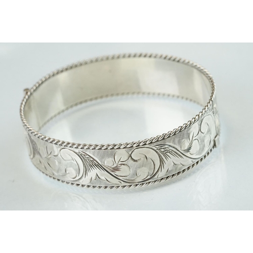 98 - Four silver hinged bangles, together with a Rennie Macintosh style cubic zirconia set silver bangle ... 