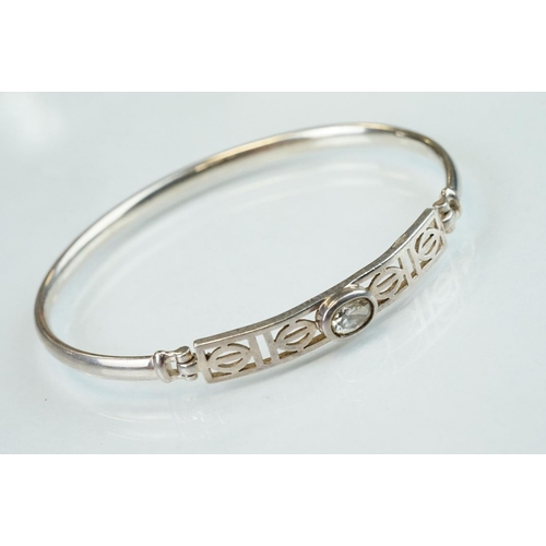 98 - Four silver hinged bangles, together with a Rennie Macintosh style cubic zirconia set silver bangle ... 