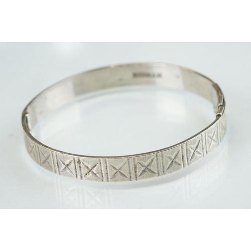 98 - Four silver hinged bangles, together with a Rennie Macintosh style cubic zirconia set silver bangle ... 