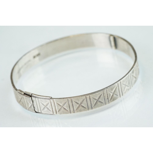 98 - Four silver hinged bangles, together with a Rennie Macintosh style cubic zirconia set silver bangle ... 