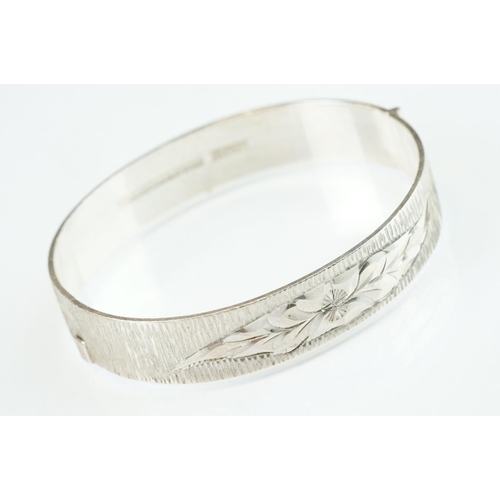 98 - Four silver hinged bangles, together with a Rennie Macintosh style cubic zirconia set silver bangle ... 