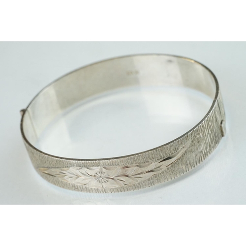 98 - Four silver hinged bangles, together with a Rennie Macintosh style cubic zirconia set silver bangle ... 