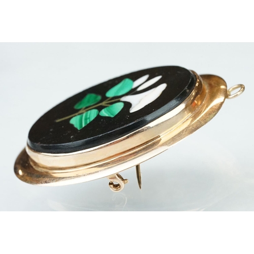 10 - Pietra dura rose metal brooch, the oval panel set with floral design, rubover set, plain polished su... 