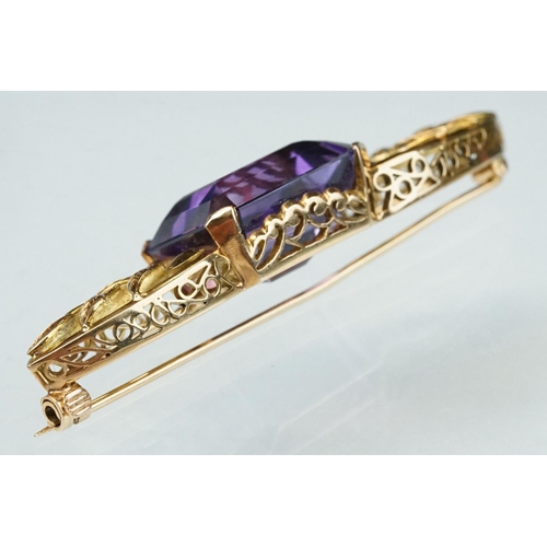 14 - Early 20th century amethyst yellow metal brooch, the rectangular mixed cut amethyst measuring approx... 