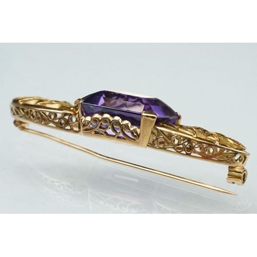 14 - Early 20th century amethyst yellow metal brooch, the rectangular mixed cut amethyst measuring approx... 