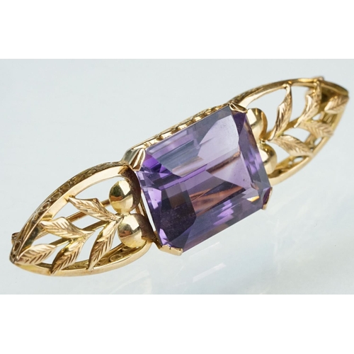 14 - Early 20th century amethyst yellow metal brooch, the rectangular mixed cut amethyst measuring approx... 