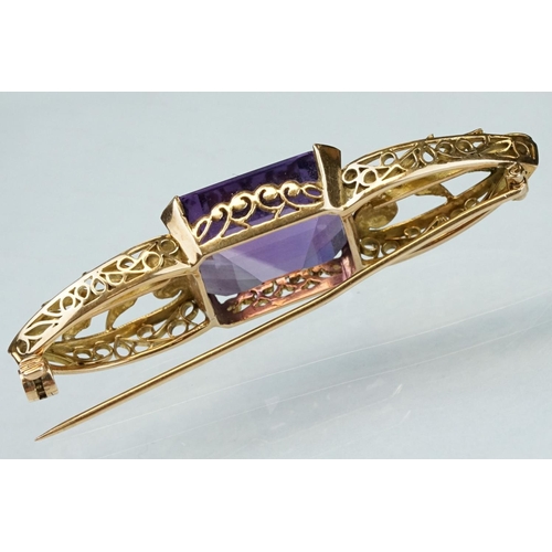 14 - Early 20th century amethyst yellow metal brooch, the rectangular mixed cut amethyst measuring approx... 