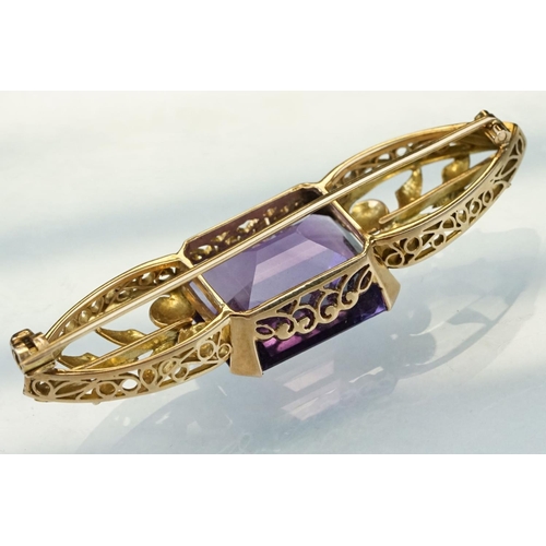 14 - Early 20th century amethyst yellow metal brooch, the rectangular mixed cut amethyst measuring approx... 