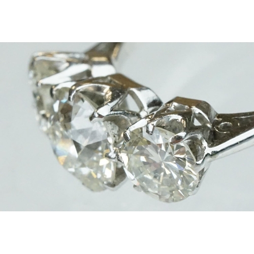 15 - Diamond 18ct white gold three stone ring, the central round brilliant cut diamond weighing approx 1.... 