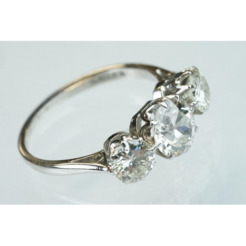 15 - Diamond 18ct white gold three stone ring, the central round brilliant cut diamond weighing approx 1.... 