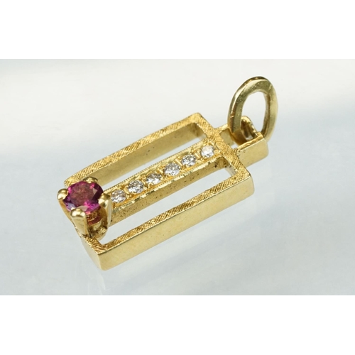 19 - Ruby and diamond 18ct yellow gold pendant, the round mixed cut ruby diameter approx 4mm, four claw s... 