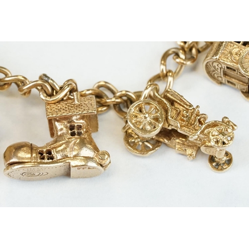 200A - 9ct yellow gold charm bracelet with padlock clasp and safety chain, eleven 9ct gold charms and one y... 