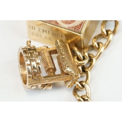 200A - 9ct yellow gold charm bracelet with padlock clasp and safety chain, eleven 9ct gold charms and one y... 