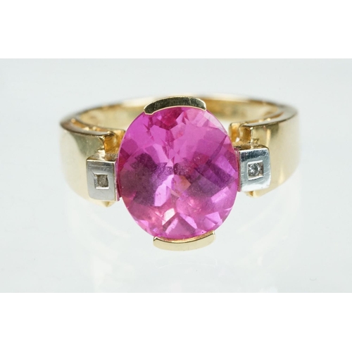 21 - Pink sapphire and diamond yellow and white gold ring, oval mixed cut pink sapphire measuring approx ... 