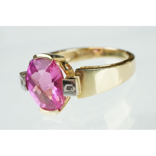 21 - Pink sapphire and diamond yellow and white gold ring, oval mixed cut pink sapphire measuring approx ... 