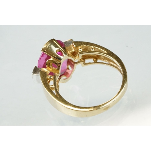 21 - Pink sapphire and diamond yellow and white gold ring, oval mixed cut pink sapphire measuring approx ... 