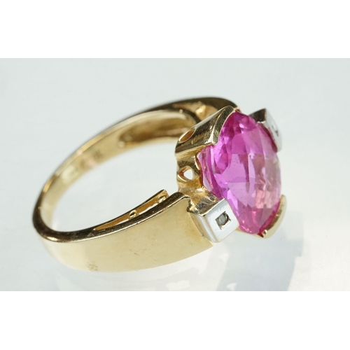 21 - Pink sapphire and diamond yellow and white gold ring, oval mixed cut pink sapphire measuring approx ... 