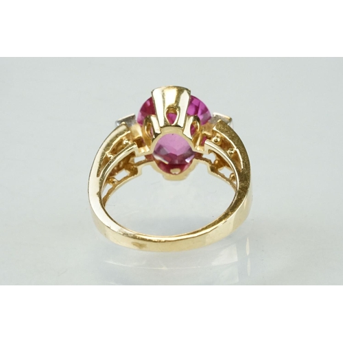 21 - Pink sapphire and diamond yellow and white gold ring, oval mixed cut pink sapphire measuring approx ... 