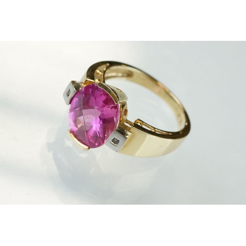 21 - Pink sapphire and diamond yellow and white gold ring, oval mixed cut pink sapphire measuring approx ... 