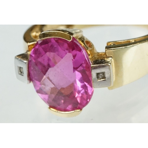 21 - Pink sapphire and diamond yellow and white gold ring, oval mixed cut pink sapphire measuring approx ... 