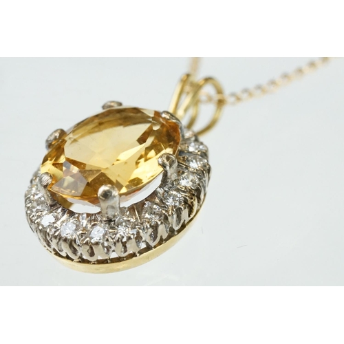 22 - Citrine and diamond unmarked yellow and white gold set pendant necklace, the oval mixed cut citrine ... 